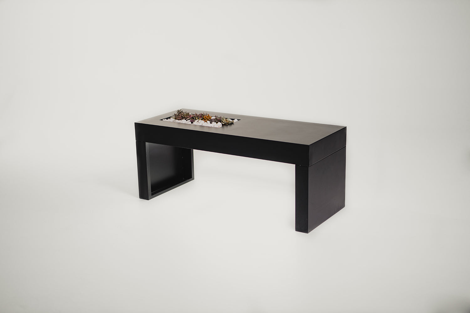 A sleek, modern black planter bench with a rectangular shape, designed to be placed on a front porch or garden area.