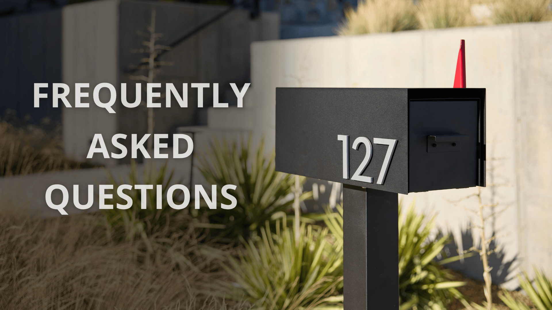 Modern black mailbox with magnetic house numbers and red flag, featured in the Post & Porch mailbox FAQ guide