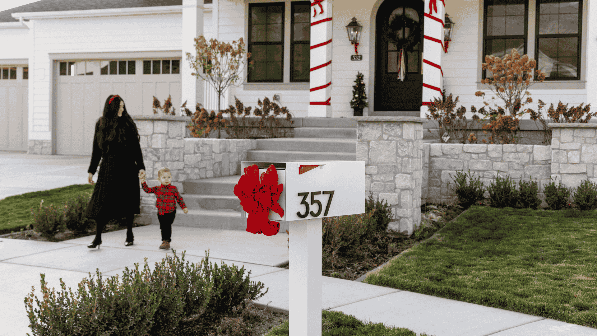 How to keep great curb appeal before winter arrives; white post-mounted mailbox with black house numbers and a red bow