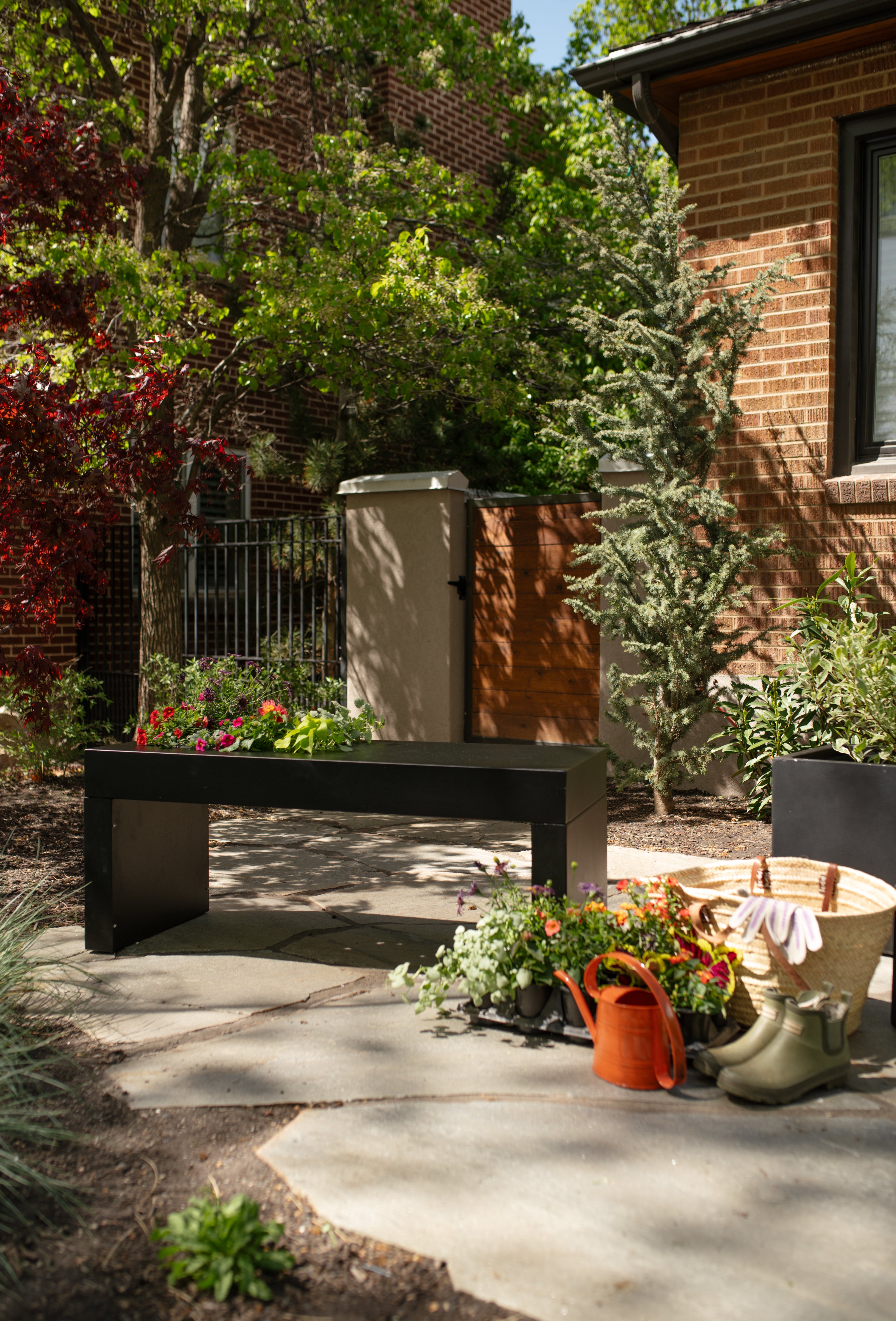 A sleek, modern Solitude Planter Bench in black color by Post & Porch