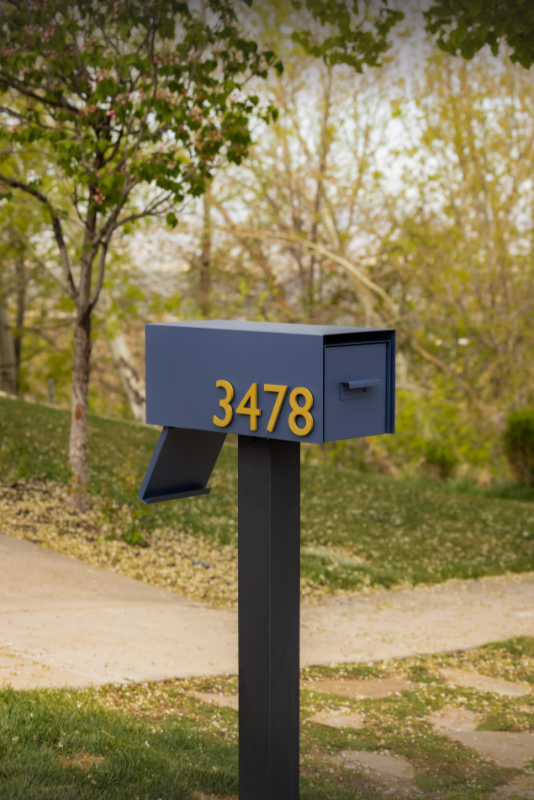 Rear-access mailbox and post with the number 3478 in a park-like setting